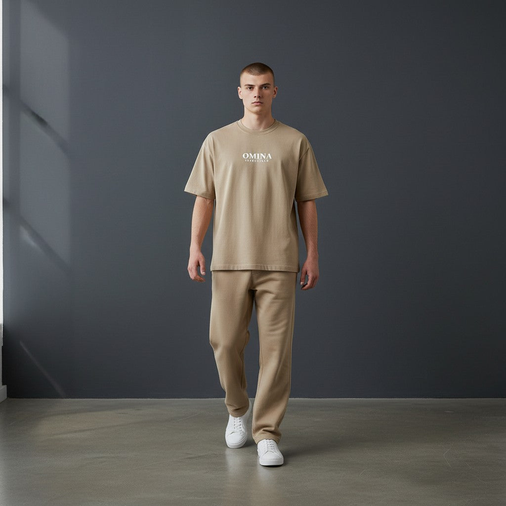 Omina Essentials No Limit heavyweight cotton t-shirt in tan with a relaxed fit and crew neck. Model wears matching pants.