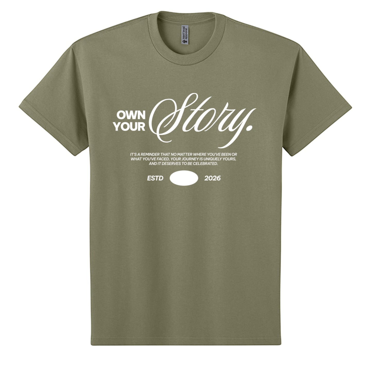 Omina Essentials olive green heavyweight cotton t-shirt with "Own Your Story" graphic print and ESTD 2026 detail.