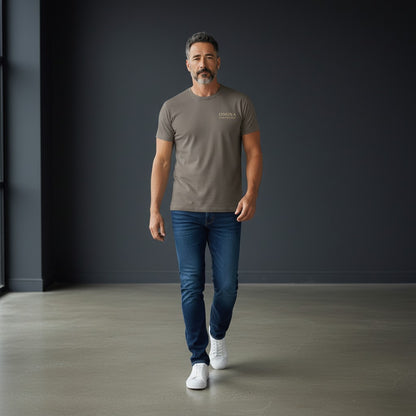 Omina Essentials taupe heavyweight combed ring-spun cotton t-shirt with minimalist logo on chest. Relaxed oversized fit.