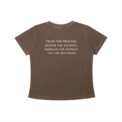 OMINA Essentials brown cotton t-shirt with vintage wash and white text reading "TRUST THE PROCESS. HONOR THE JOURNEY. EMBRACE THE WOMAN YOU ARE BECOMING."