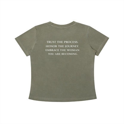 OMINA Essentials olive green cotton t-shirt with vintage wash and white text reading "TRUST THE PROCESS. HONOR THE JOURNEY. EMBRACE THE WOMAN YOU ARE BECOMING."