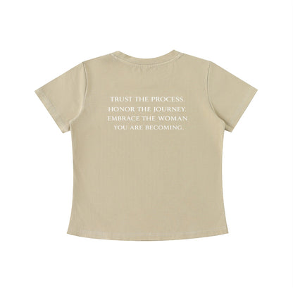 OMINA Essentials beige cotton t-shirt with vintage wash and white text on back: "TRUST THE PROCESS. HONOR THE JOURNEY. EMBRACE THE WOMAN YOU ARE BECOMING."