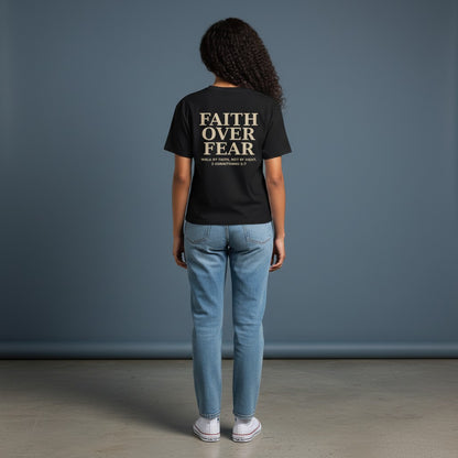 Omina black cotton blend crewneck t-shirt with "Faith Over Fear" graphic and Bible verse 2 Corinthians 5:7 on back.