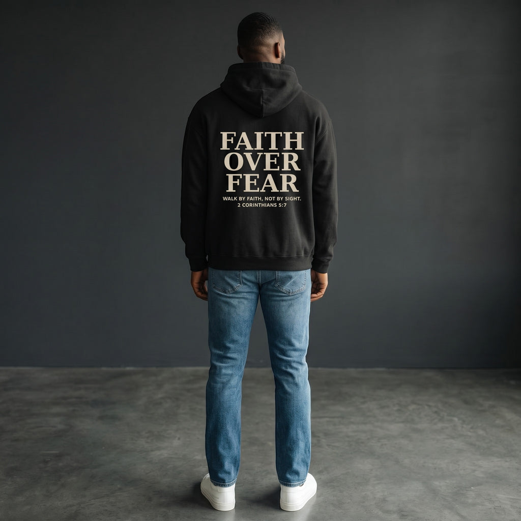 Omina black oversized pullover hoodie with "FAITH OVER FEAR" graphic and Bible verse 2 Corinthians 5:7 on back.