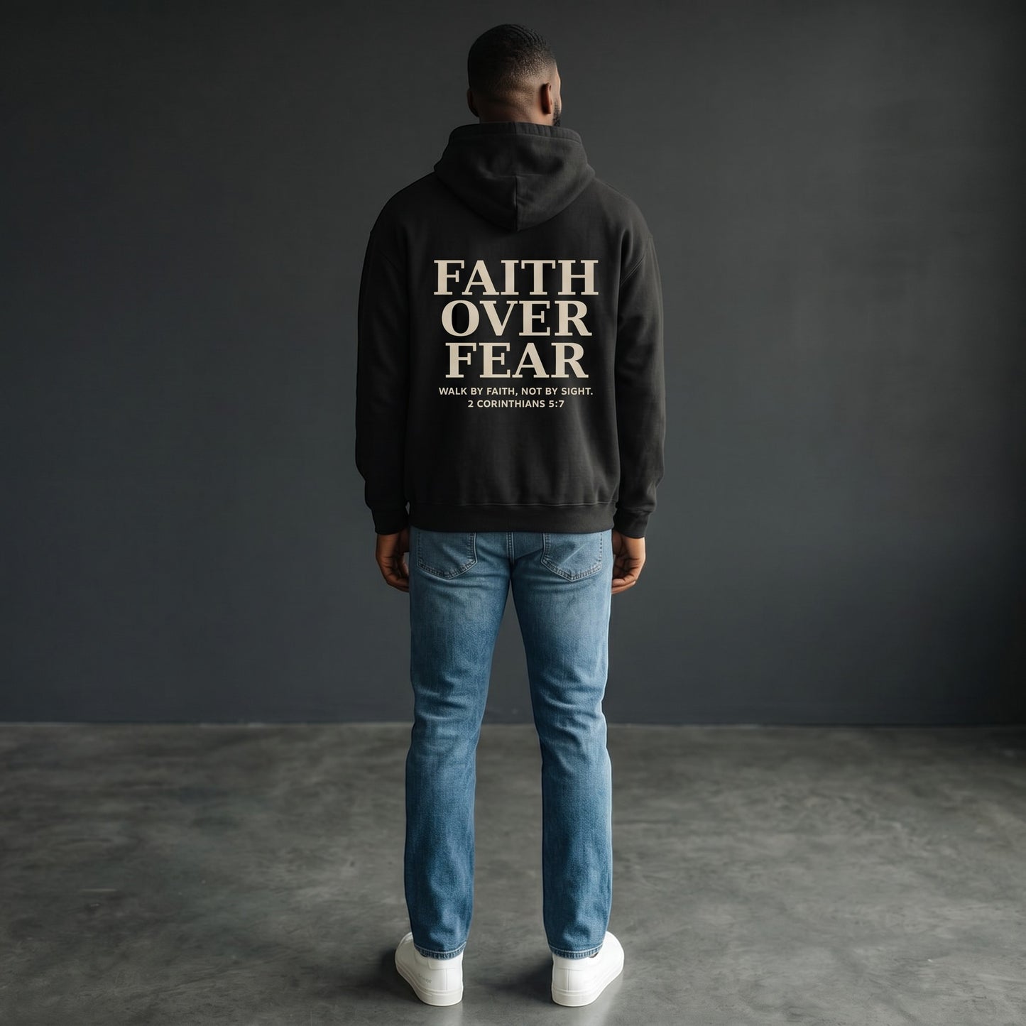 Omina black oversized pullover hoodie with "FAITH OVER FEAR" graphic and Bible verse 2 Corinthians 5:7 on back.
