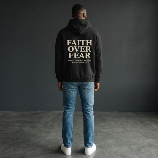 Omina black oversized pullover hoodie with "FAITH OVER FEAR" graphic and Bible verse 2 Corinthians 5:7 on back.