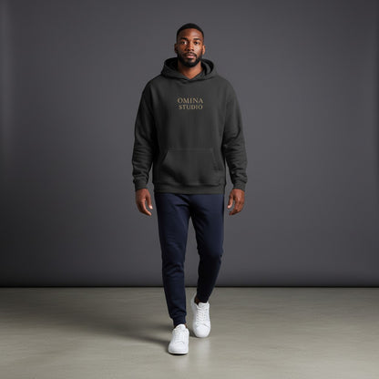 OMINA STUDIO black oversized pullover hoodie with minimalist chest logo and large "FAITH OVER FEAR" graphic on back.