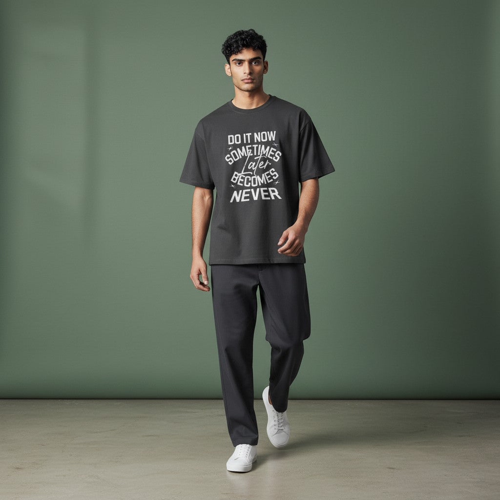 Model wearing a charcoal Omina graphic t-shirt with Do It Now text, made from premium combed cotton.