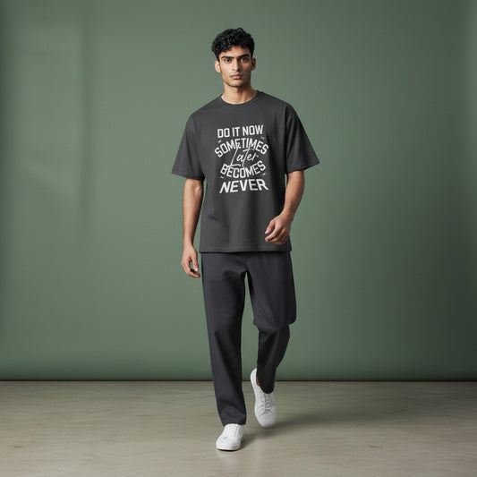 Model wearing a charcoal Omina graphic t-shirt with Do It Now text, made from premium combed cotton.