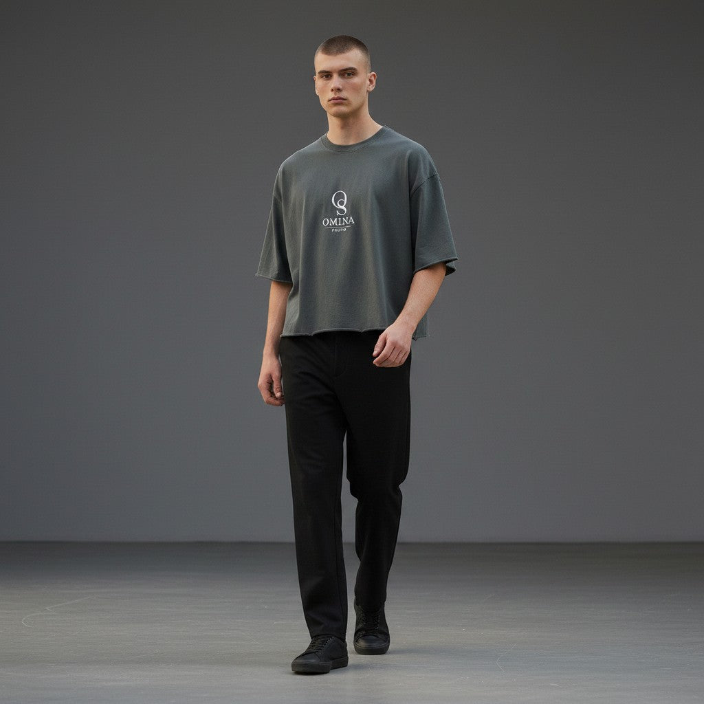 OMINA grey heavyweight cotton boxy t-shirt with raw edge hem and graphic logo, worn by a male model.