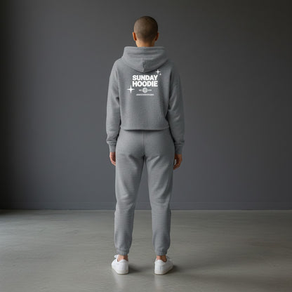 Omina Essentials grey cropped Sunday hoodie with white back graphic worn with matching joggers by a model
