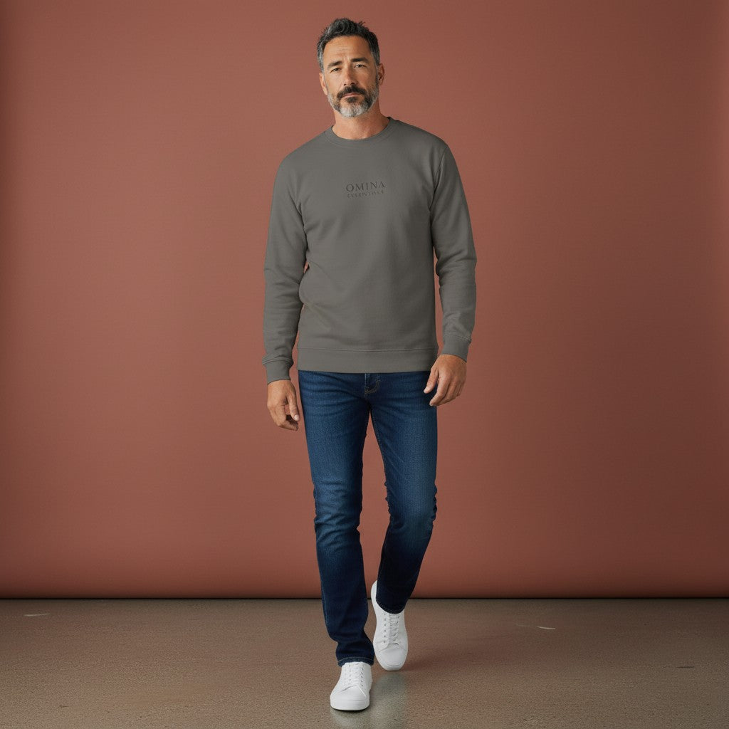 A man wearing an Omina grey heavyweight cotton long sleeve shirt with a relaxed fit and crew neck, styled with jeans.