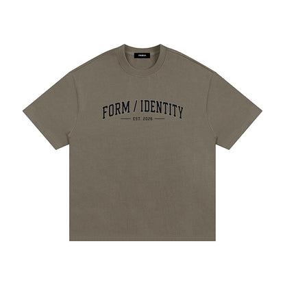 Omina Studio heavyweight cotton t-shirt in olive green with "FORM / IDENTITY EST. 2026" graphic on front.