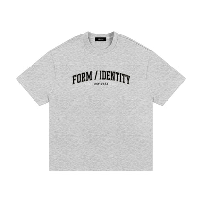 OMINA Studio grey heavyweight cotton t-shirt with "FORM / IDENTITY EST. 2026" graphic on front. Relaxed fit.