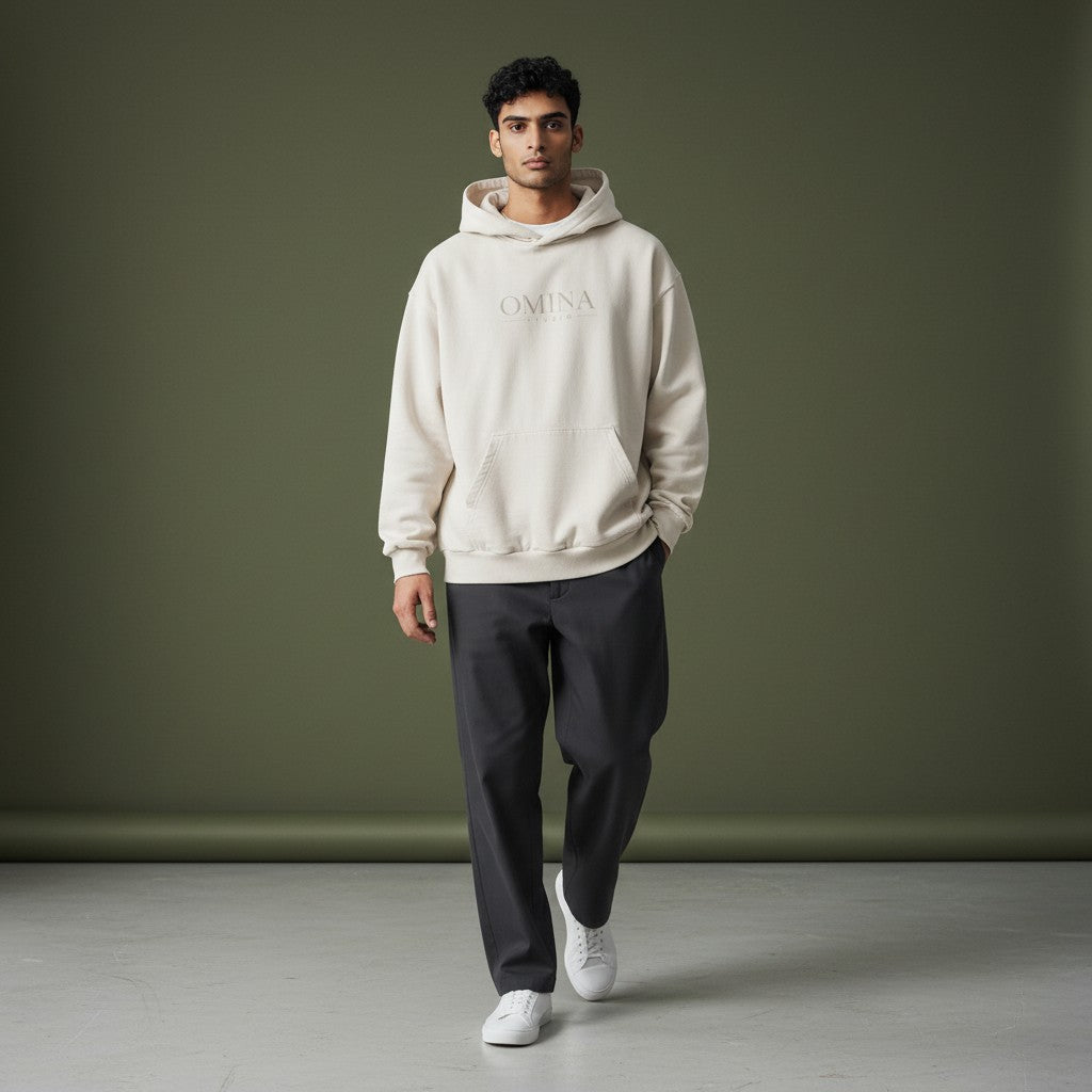 OMINA Studio heavyweight beige cotton hoodie with kangaroo pocket and washed effect. Minimalist front logo.