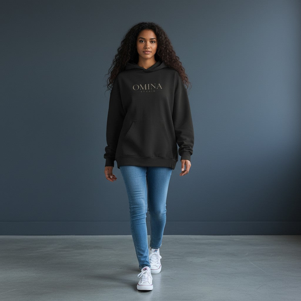 OMINA Studio heavyweight black cotton hoodie with kangaroo pocket and minimalist front logo. Boxy fit.