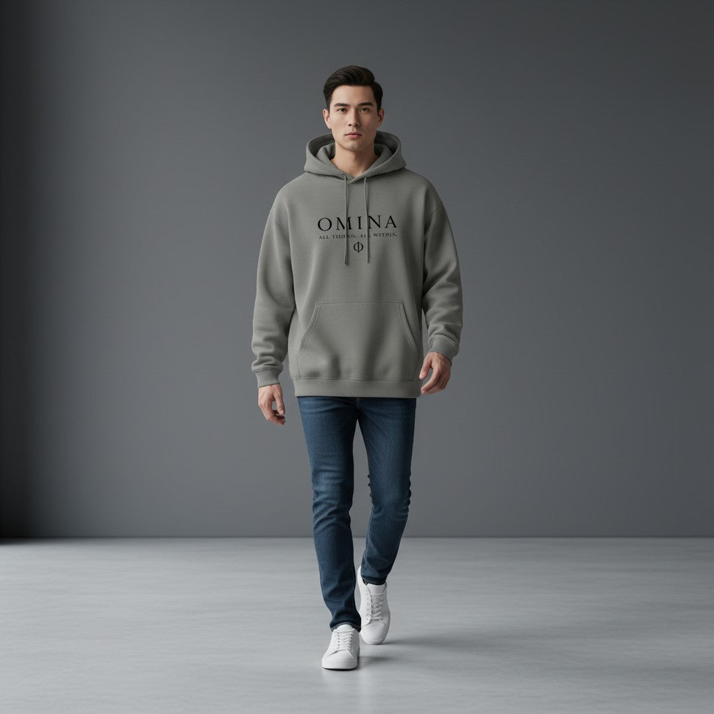 Omina Studio grey heavyweight fleece drop-shoulder hoodie with black text logo and symbol.