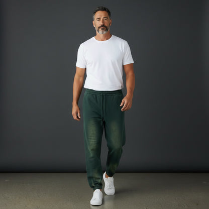 OMINA Studio vintage-inspired heavyweight fleece sweatpants in dark green with a washed finish and adjustable drawstrings.