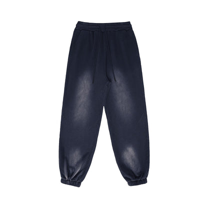 Omina Studio vintage-inspired heavyweight sweatpants in washed navy blue fleece with elastic waistband and drawstrings.