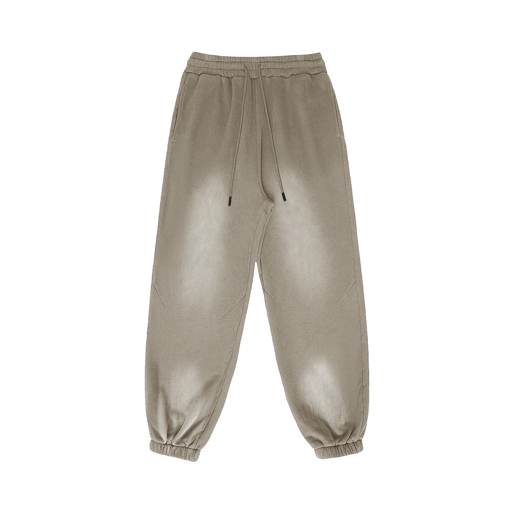 Omina Studio vintage-inspired heavyweight fleece sweatpants in a washed taupe color with elastic waistband and drawstrings.