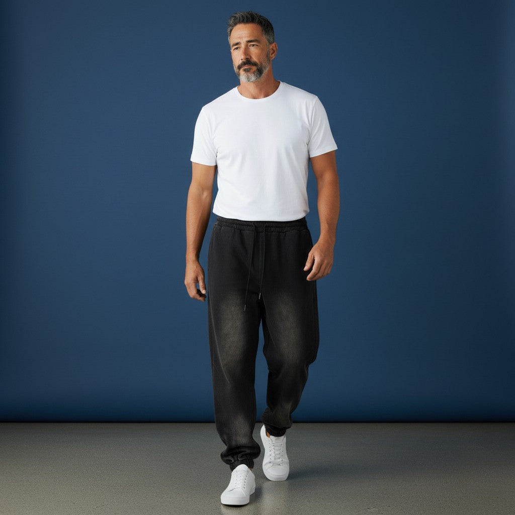 Omina Studio vintage-inspired heavyweight sweatpants in washed black fleece with elastic waistband and drawcord.