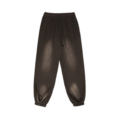Omina Studio vintage-inspired heavyweight fleece sweatpants in a washed brown color with an elastic waistband and drawstrings.