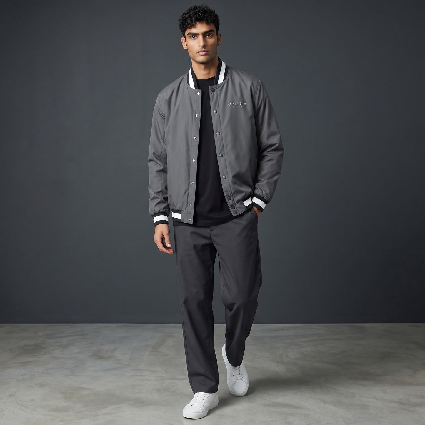 Omina grey insulated varsity jacket with white striped collar, cuffs, and hem. Water-resistant exterior.