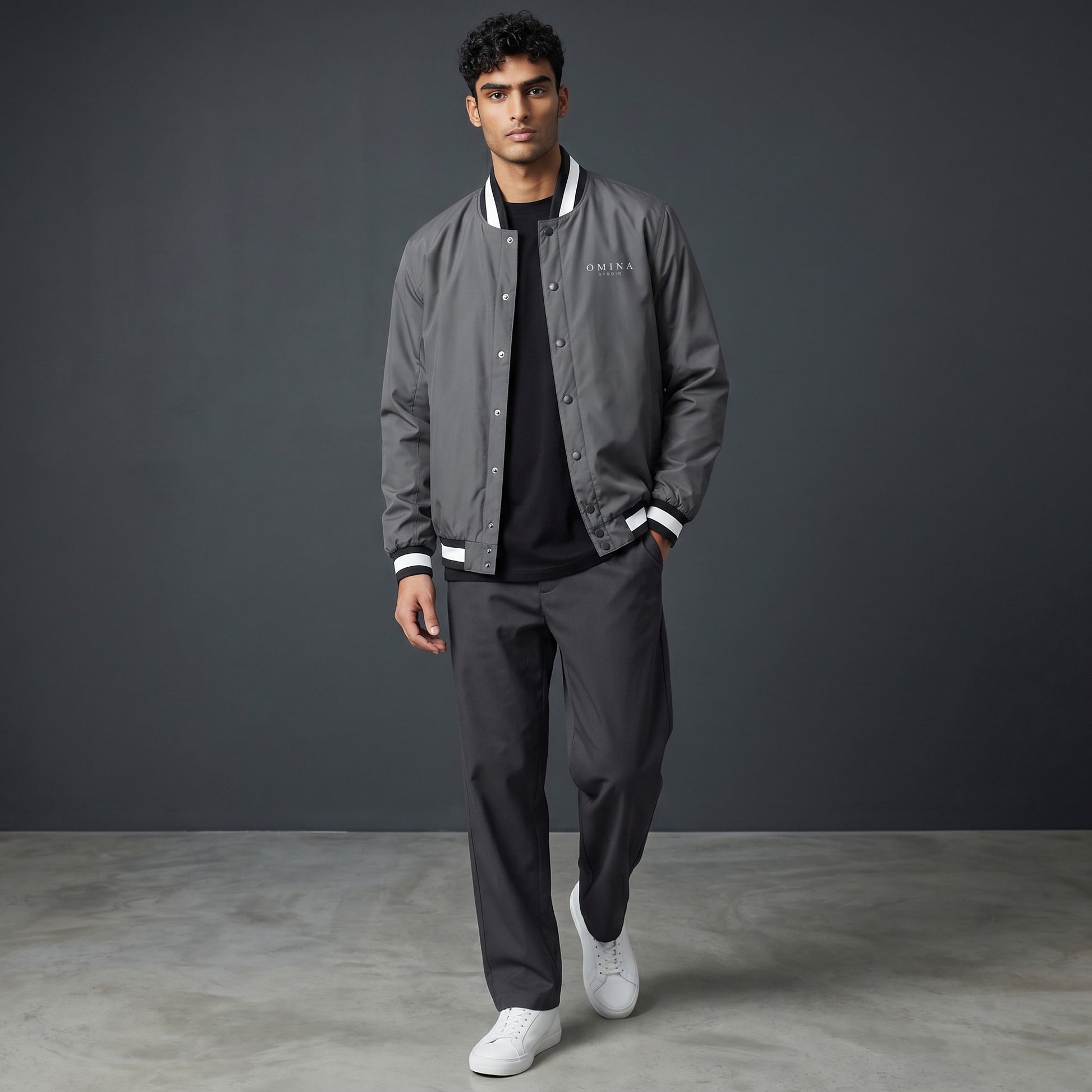 Omina grey insulated varsity jacket with white striped collar, cuffs, and hem. Water-resistant exterior.