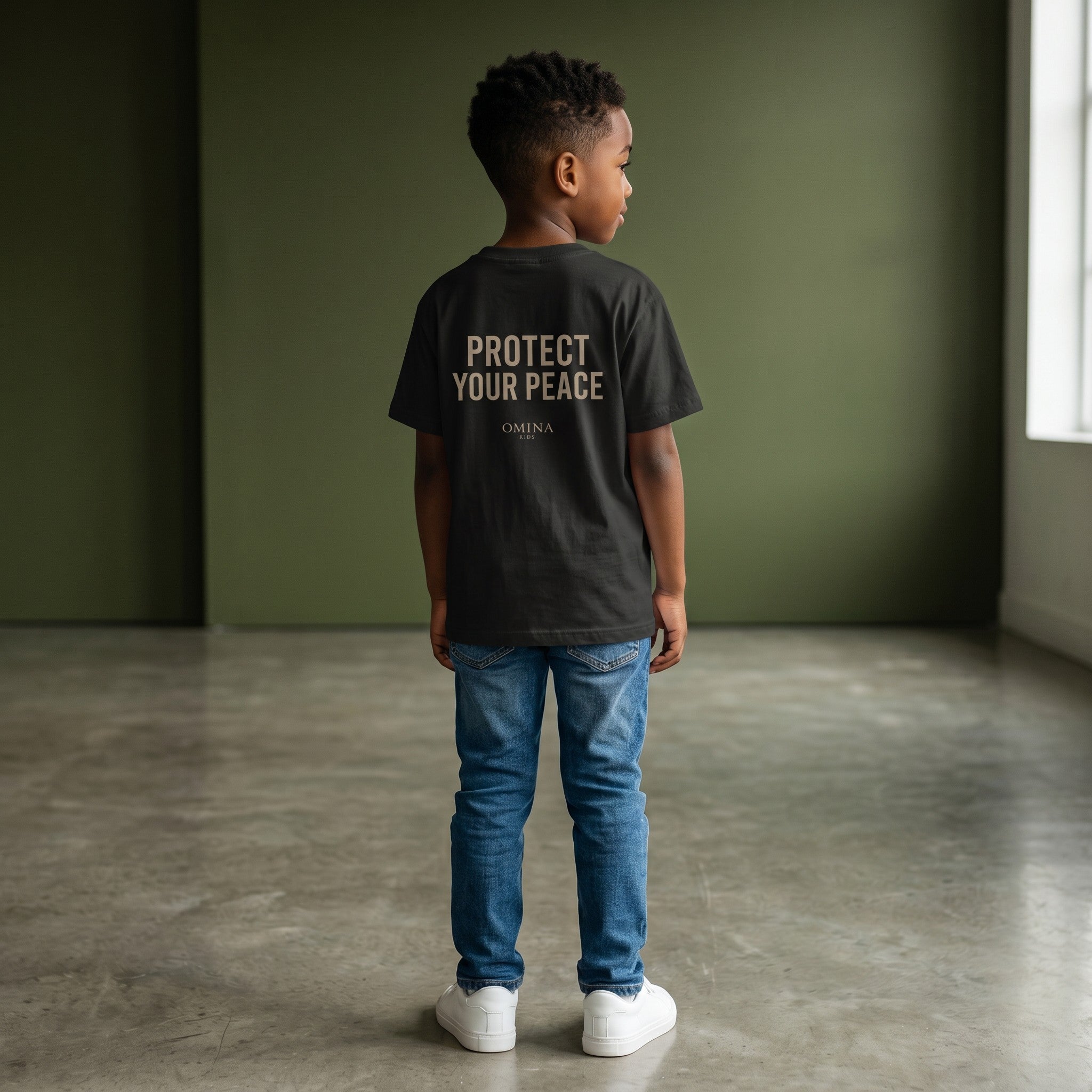 Omina Kids black cotton t-shirt with "PROTECT YOUR PEACE" graphic and Omina Kids logo.