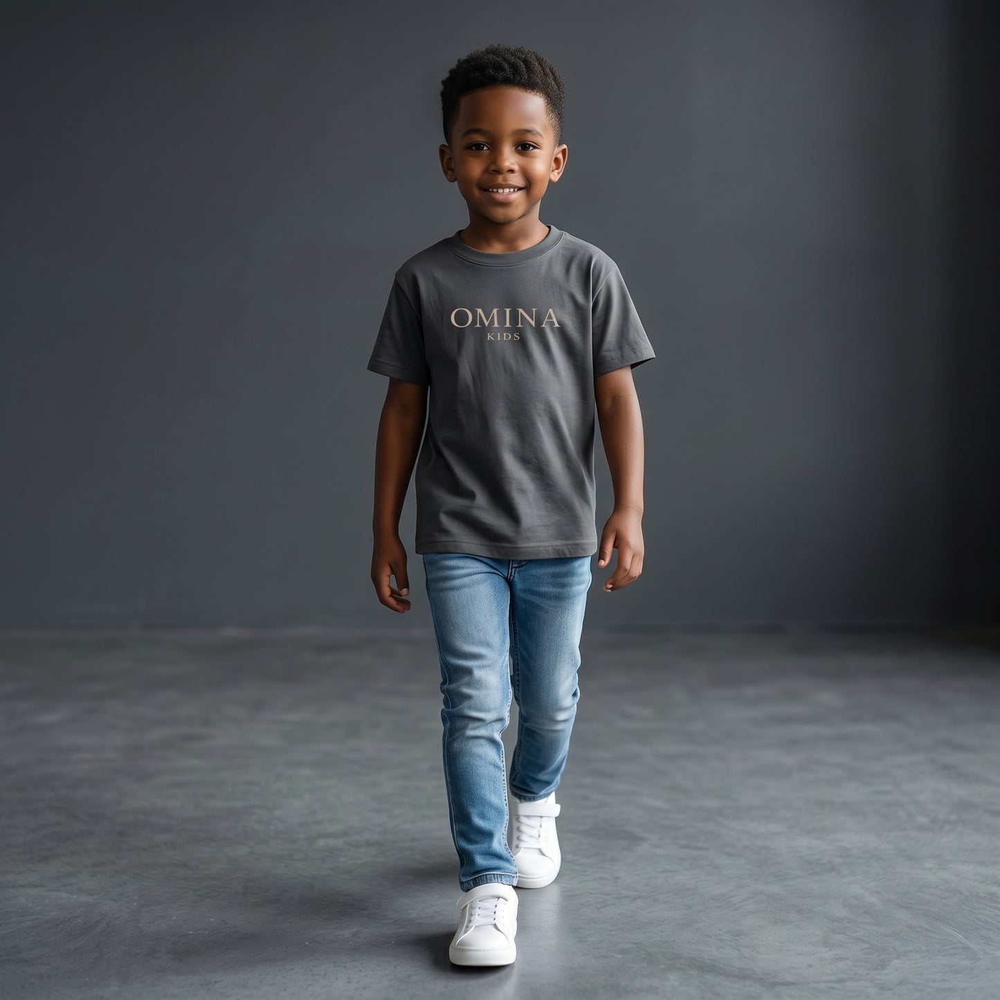 Omina Kids essential t-shirt in dark grey, made from soft, breathable fabric with a relaxed fit and subtle Omina Kids branding.