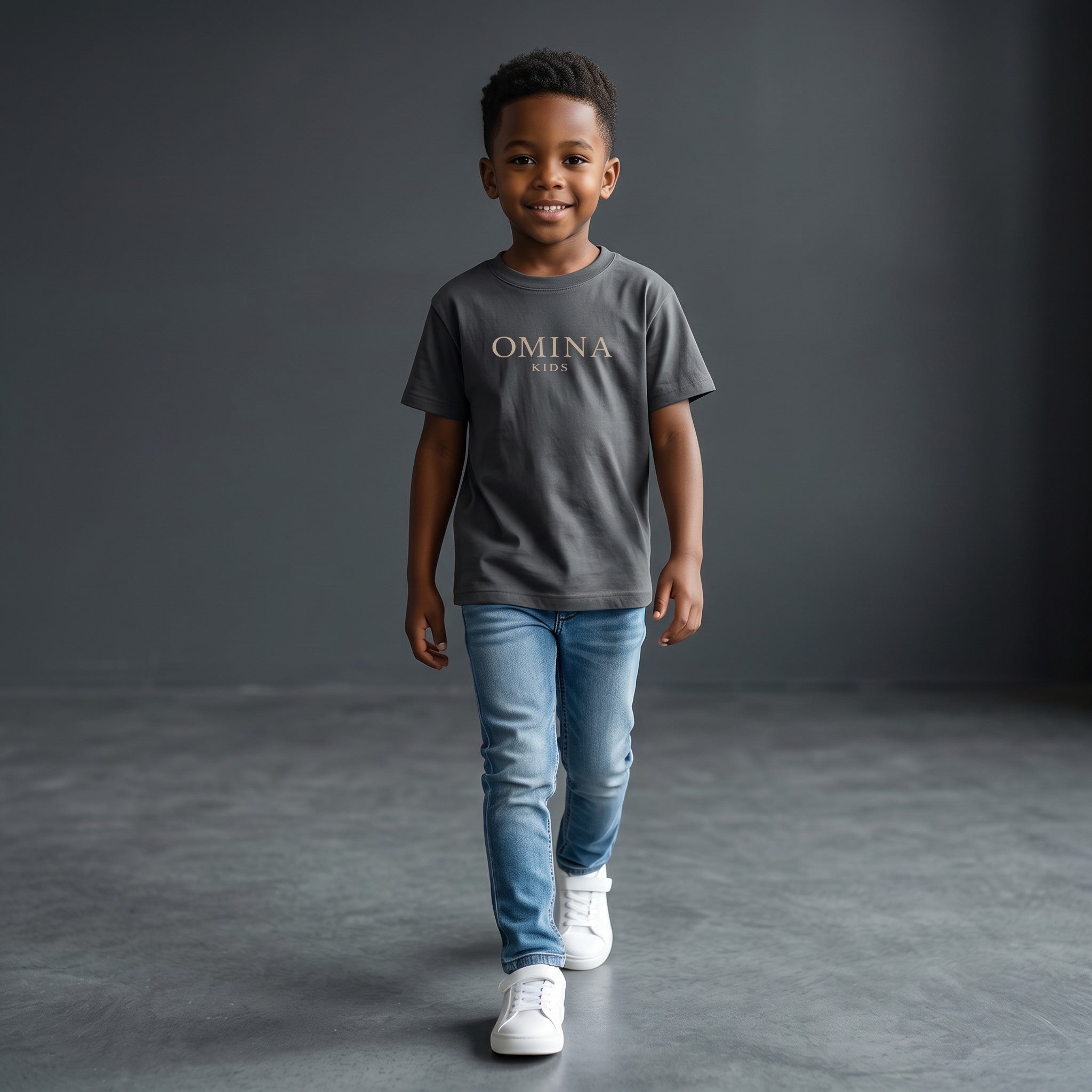 Omina Kids essential t-shirt in dark grey, made from soft, breathable fabric with a relaxed fit and subtle Omina Kids branding.