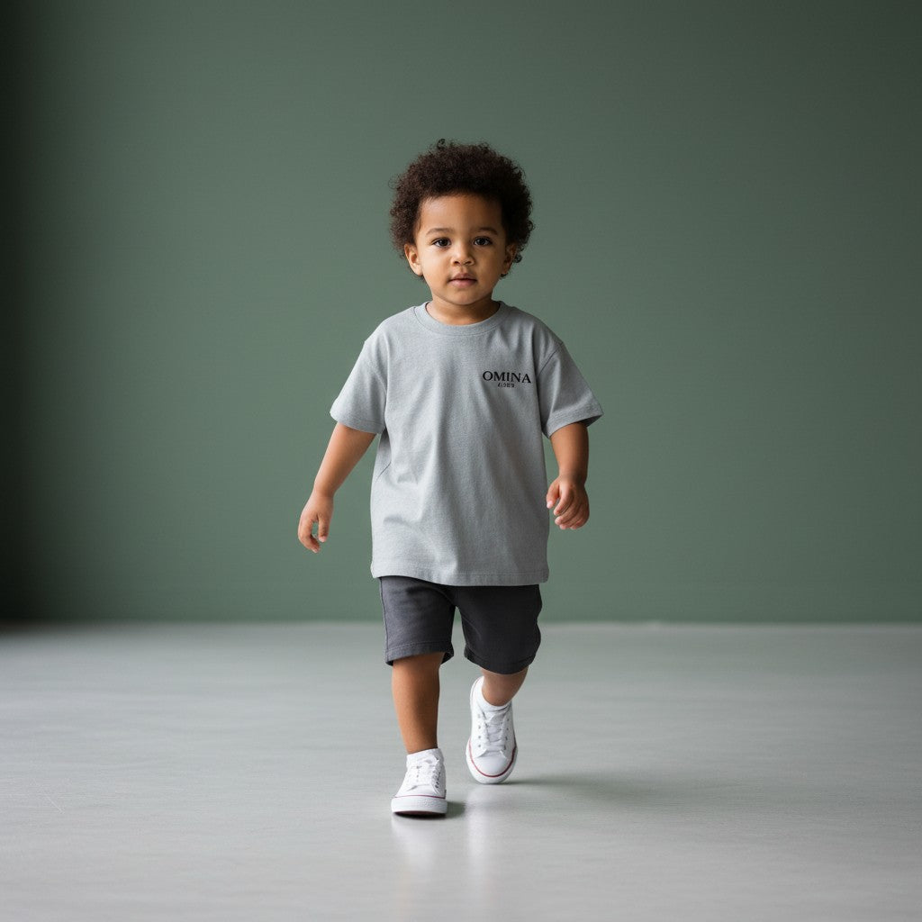 Omina Kids grey triblend toddler tee with "SMALL HUMAN. BIG ENERGY." graphic on chest.