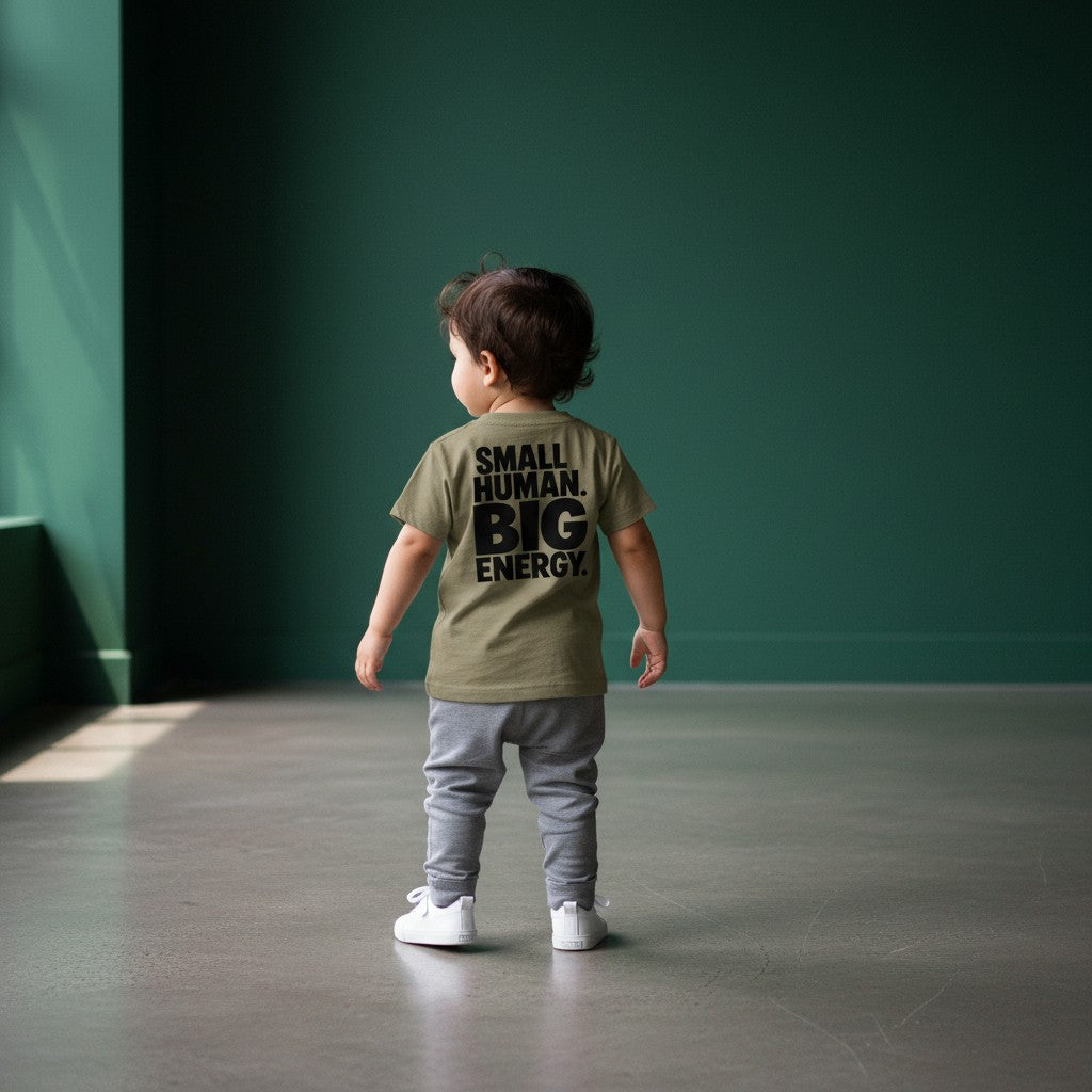 Omina Kids toddler tee in tan with black text reading "SMALL HUMAN. BIG ENERGY."