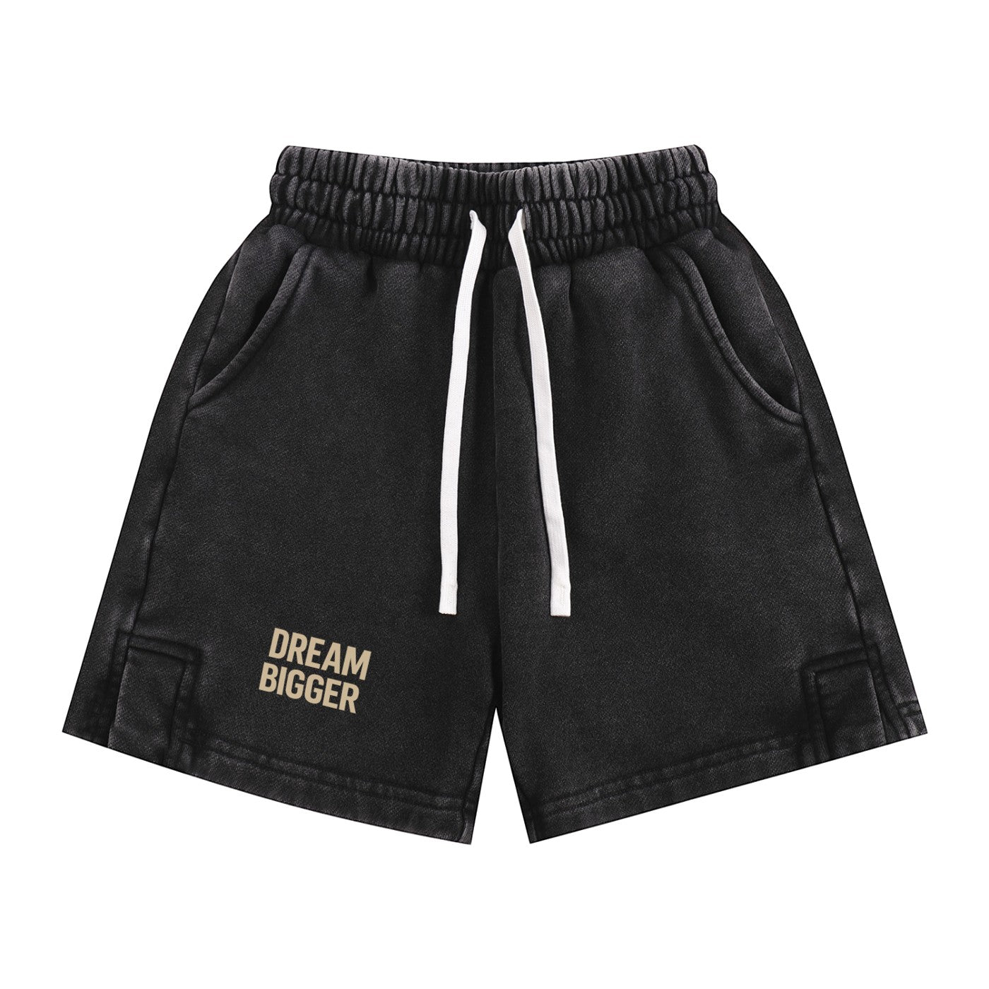 Omina Kids snow-washed black shorts with elastic waistband, white drawstring, and "DREAM BIGGER" graphic.