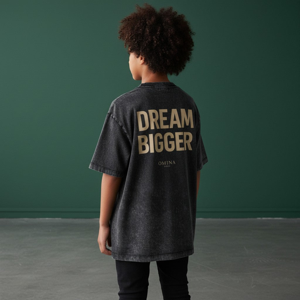 Omina Kids' snow-washed charcoal grey 100% cotton t-shirt with 'DREAM BIGGER' graphic print.