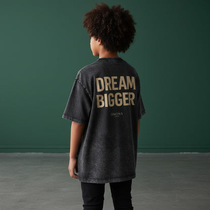 Omina Kids' snow-washed charcoal grey 100% cotton t-shirt with 'DREAM BIGGER' graphic print.