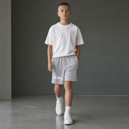 Omina Kids Youth Form / Identity shorts in light grey with elastic waistband and white graphic logo on left leg.