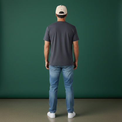Man wearing an Omina beige 5-panel mid profile baseball cap with a snapback closure against a green background.