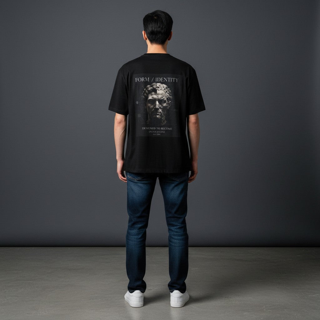 Man wearing Omina black ring-spun cotton t-shirt with Form Identity graphic print on the back, paired with blue jeans.