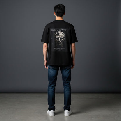 Man wearing Omina black ring-spun cotton t-shirt with Form Identity graphic print on the back, paired with blue jeans.