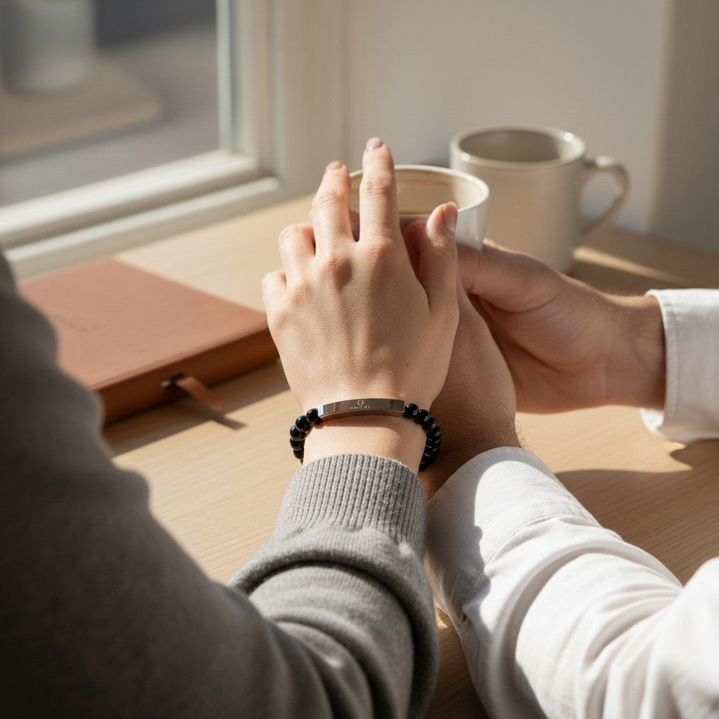 Omina natural stone stretch bracelet with a stainless steel bar, worn by a person holding hands with another.