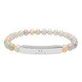 Omina natural stone stretch bracelet with neutral marbled beads and a polished stainless steel engraved bar.