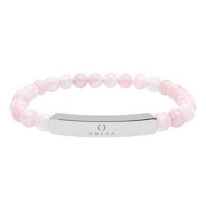 Omina stretch bracelet featuring smooth light pink natural stone beads and a polished stainless steel engraved bar.