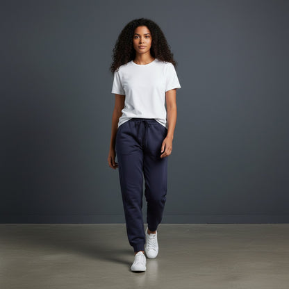 A model wearing Omina Essentials navy blue drawstring jogger pants and a white t-shirt in a studio setting.