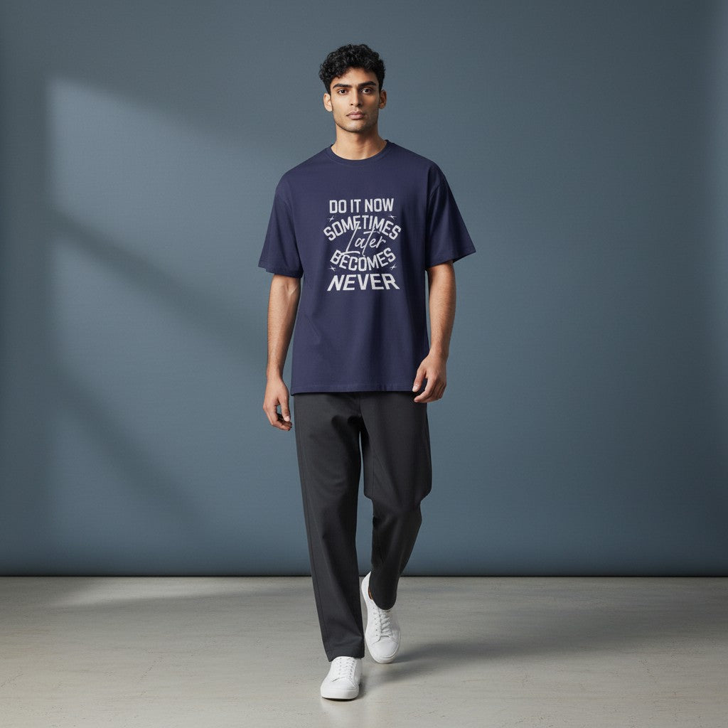 Model wearing a navy Omina classic fit combed cotton t-shirt with Do It Now graphic print in a studio setting.