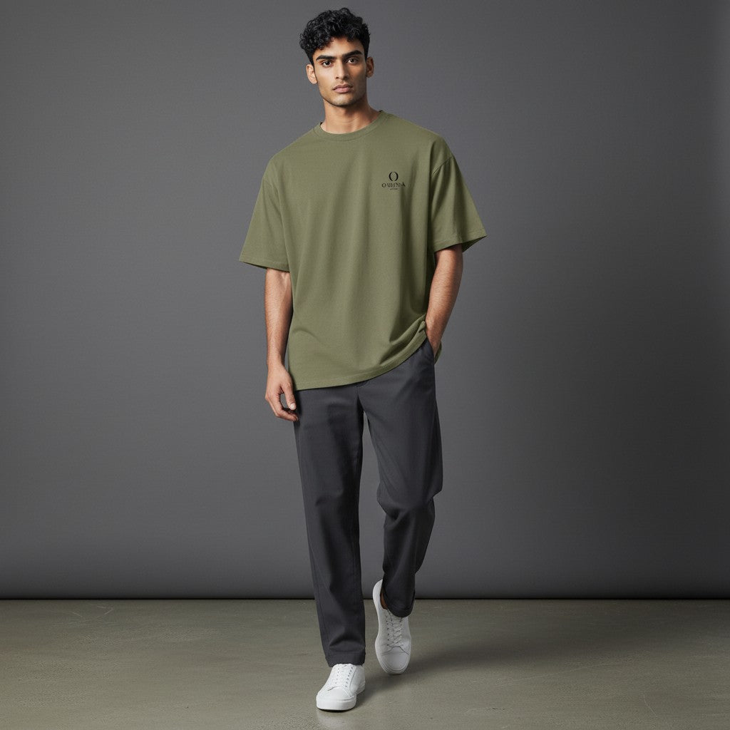 Male model wearing an Omina olive green heavyweight cotton t-shirt with a relaxed fit and small chest logo.
