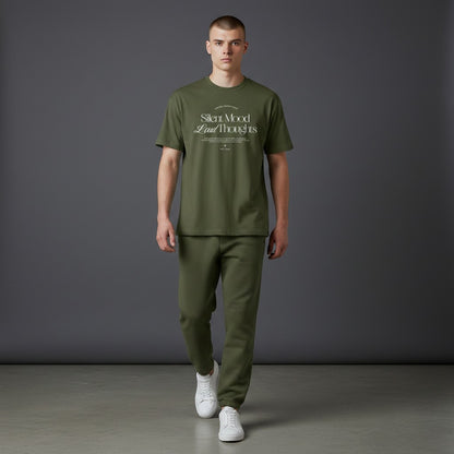 Omina Silent Mood olive green cotton jersey t-shirt worn by a male model with matching joggers and white sneakers.