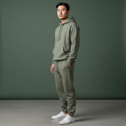Omina Studio olive green heavyweight cotton blend sweatpants with elastic waistband, drawcord, and subtle logo.