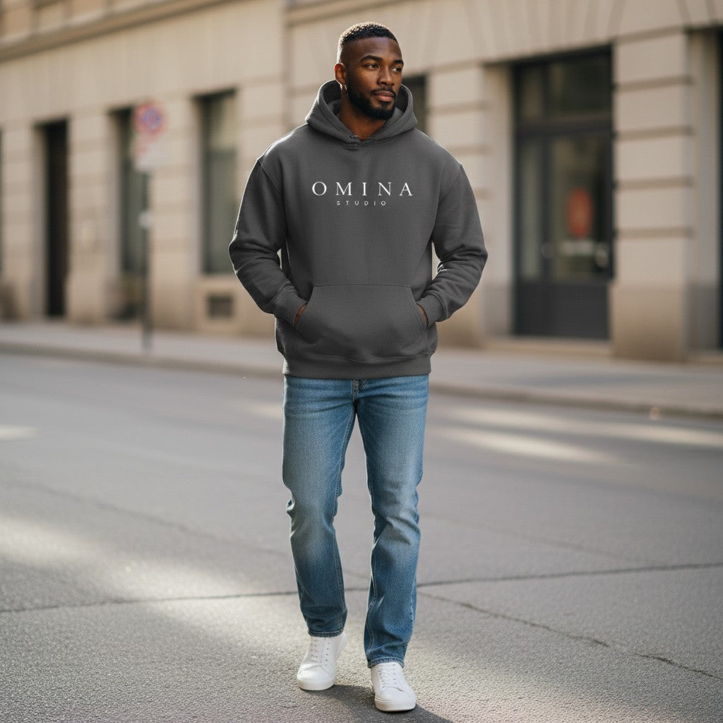 Omina Studio charcoal grey oversized fleece hoodie with white logo on chest and front pocket. Long sleeves, hooded.