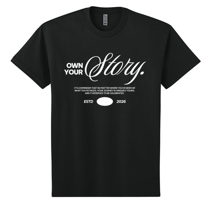 Omina black heavyweight cotton oversized t-shirt with white "Own Your Story" graphic and ESTD 2026.